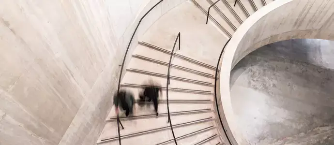 Downward view of people walking up a staircase