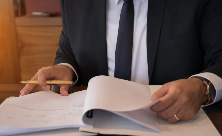 lawyer signing documents in office