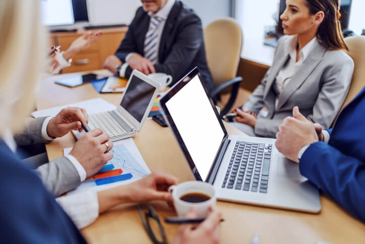 Office employees sitting at a table