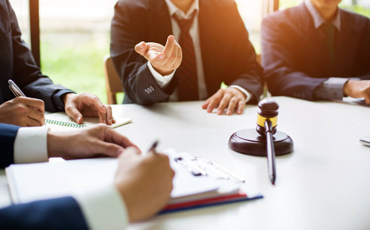 Group of lawyers discussing contract