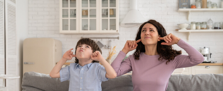 Mother and son frustrated at the loud noise from a neighbor